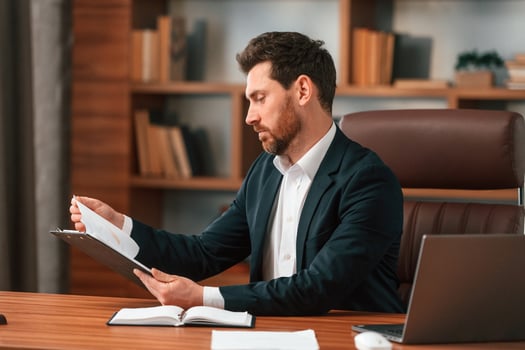 Working with documents.. Businessman in formal clothes is indoors photo