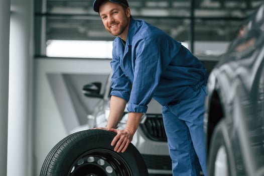 Man in blue ,uniform is working in the car service photo