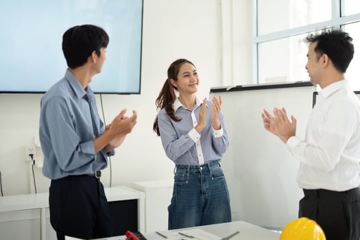 Positive Work Environment and Team Recognition. Architects and engineers applaud each other's contributions. photo