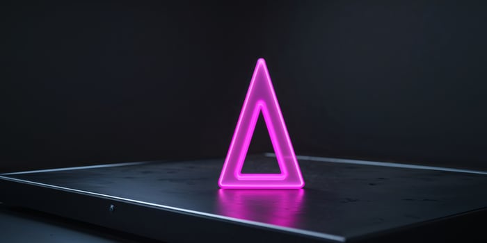 Glowing Pink Neon Triangle on Dark Platform photo