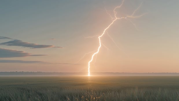 Dramatic lightning strike over a field at sunset photo