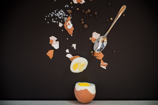 simple breakfast.Boiled egg with spices and shell on black background photo