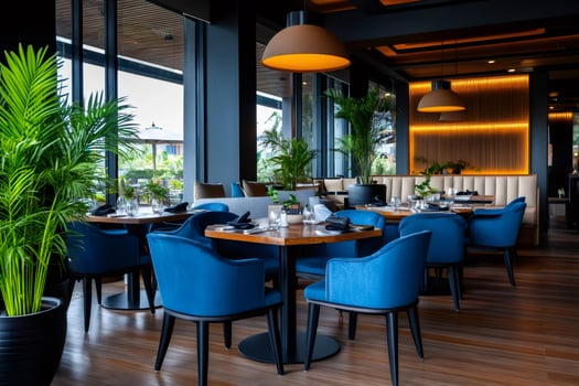 Modern restaurant interior design with blue velvet chairs and wooden tables photo