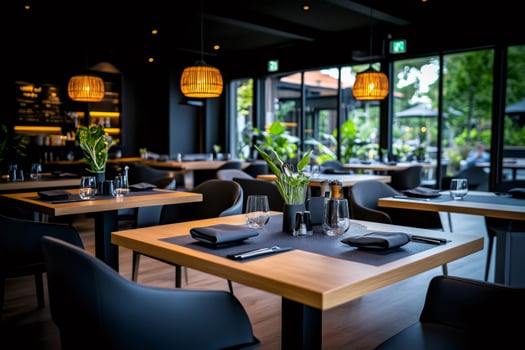 Modern restaurant interior design with wooden tables and hanging lamps photo