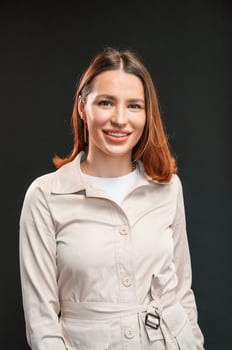 Young ,woman ,with aligner is standing against black background photo