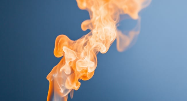 A vibrant swirl of orange flames against a blue background. photo