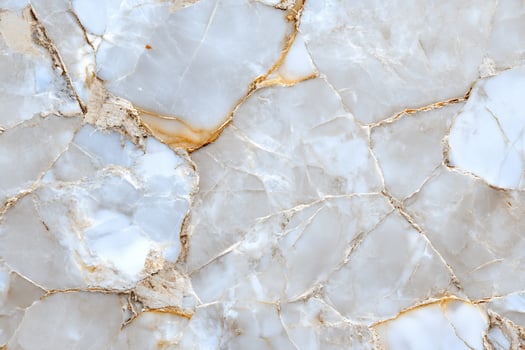 Close-up of a light-colored marble surface with natural veining. photo
