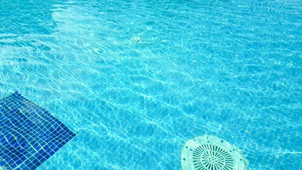 A pool with a sun umbrella photo