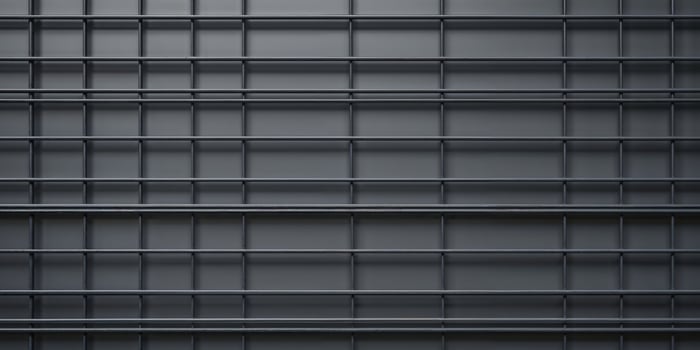 A black metal wall with many bars photo