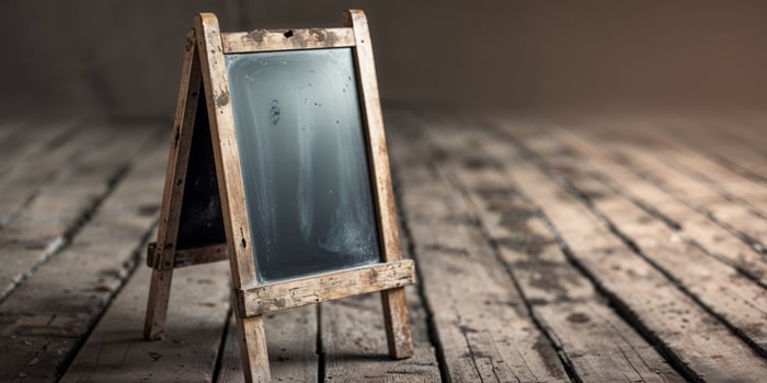 A blackboard on a wooden table with a wooden floor photo