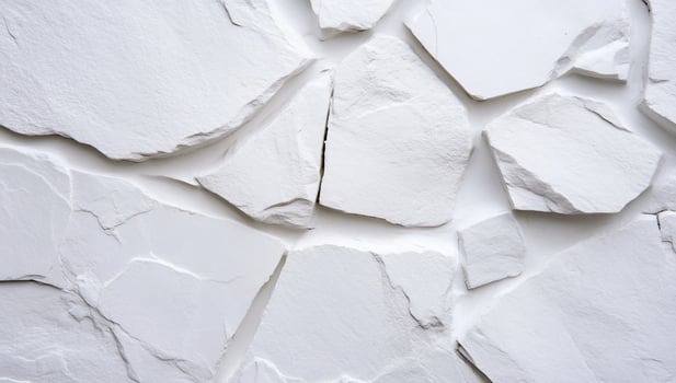Close-up of a textured white stone wall with irregular shapes. photo