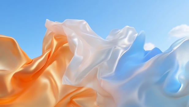 Flowing silk fabrics in orange, white, and blue against a bright sky. photo