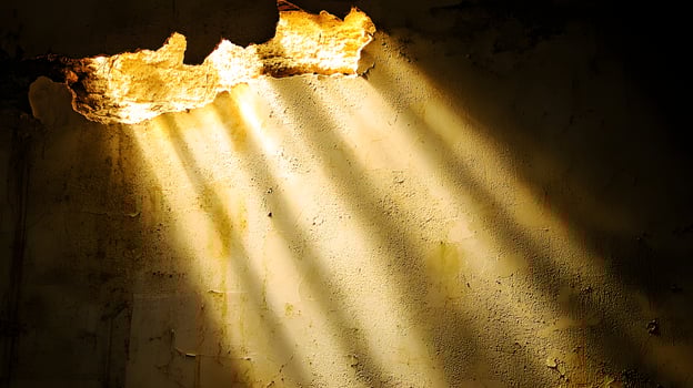Dramatic Light Beams Through Hole in Aged Textured Wall Grunge Background photo