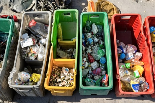 Colorful plastic crates overflowing with sorted plastic waste for recycling photo