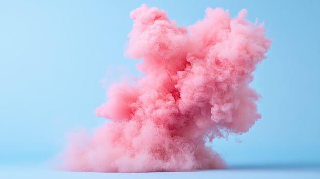 Pink smoke on blue background photo