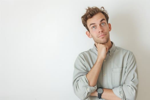 Perplexed Young Caucasian Man with a Puzzled Expression in a Studio Setting photo