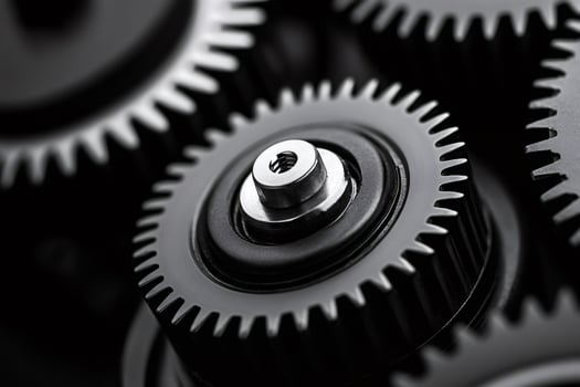 Close up of interlocking gears rotating smoothly in a complex mechanism photo