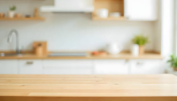Wooden table in a bright, modern kitchen with blurred background photo
