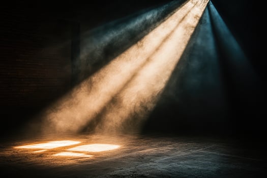 Light beams shining through smoke in dark room with brick wall photo