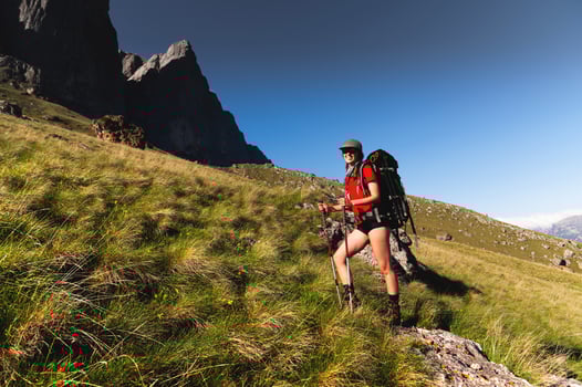 Girl Traveler hiking with backpack at rocky mountains landscape Travel Lifestyle concept adventure summer vacations outdoor photo