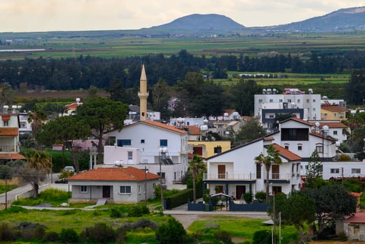 Charming village in Cyprus showcasing traditional architecture and scenic mountains in the backdrop during a serene afternoon photo