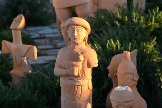 Ethereal terracotta figurines grace a sunlit garden in the heart of cultural heritage, showcasing artistry from ancient civilizations photo