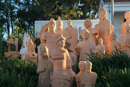 Stunning collection of terracotta sculptures displayed in serene outdoor setting during golden hour photo