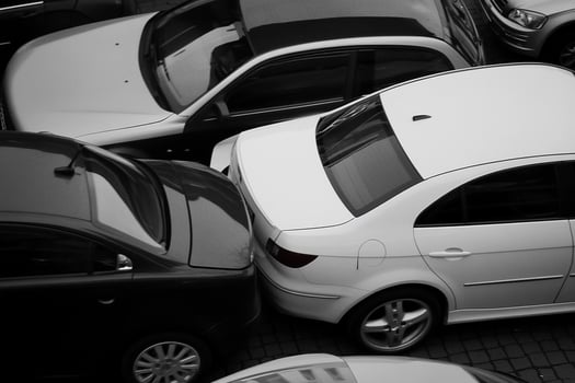 Black and white photo of cars parked in a parking lot