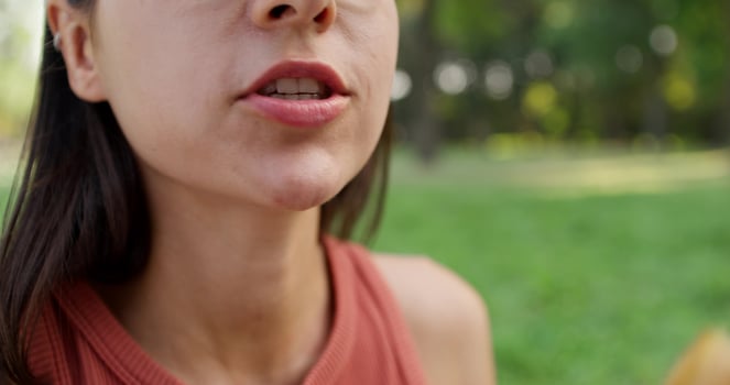 A woman is eating a piece of bread photo