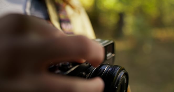 The woman adjusts the camera photo