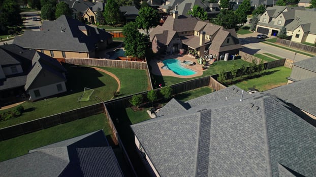 The drone flies over houses in the residential area of America. Low-rise buildings photo