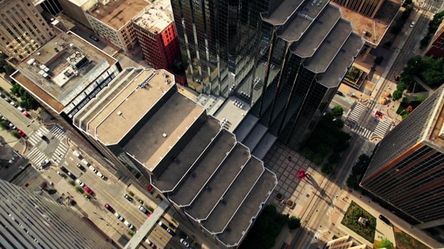 The drone flies over the roofs of skyscrapers. View of the street of the American city from above. Summer day photo