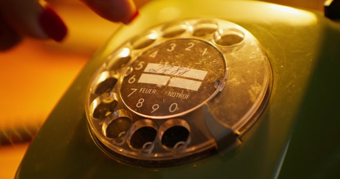 A person is holding a green telephone photo