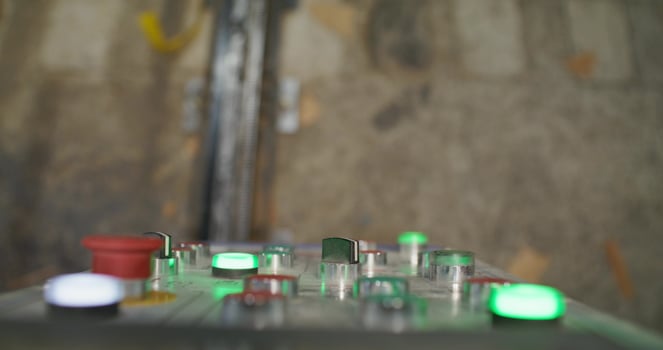A man presses the machine control button while working in a factory. Close-up of his hands, an unrecognizable person photo
