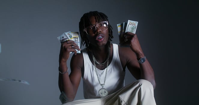 A man is holding up money in front of him photo