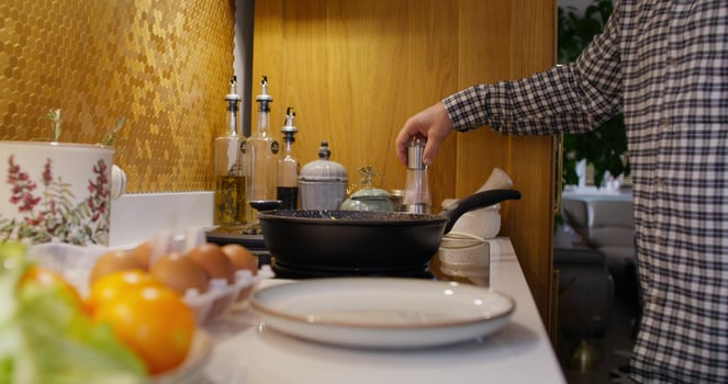 A person cooking food in a kitchen photo