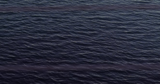 An aerial view of the ocean with a boat in the water photo