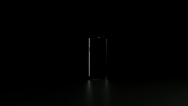 A single-color screen lights up on a phone standing on a dark surface. photo