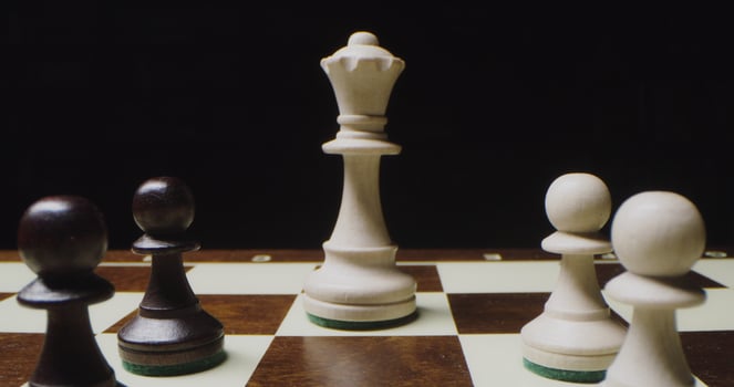 Chess stand in even rows on the game board. Pawns lined up in front of the king photo
