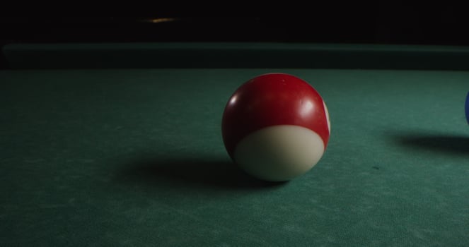 Multi-colored billiard balls in a chaotic manner lie on the billiard table, slow shooting without moving objects, without people in the frame - manner photo