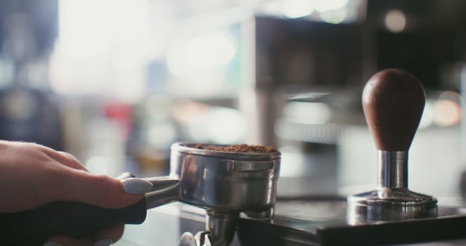 A person is using an espresso machine to make coffee photo