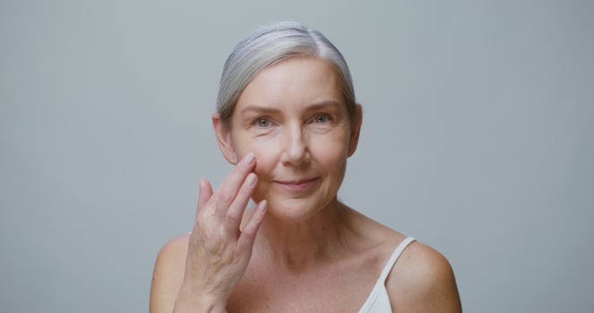 An older woman with her hand on her face photo