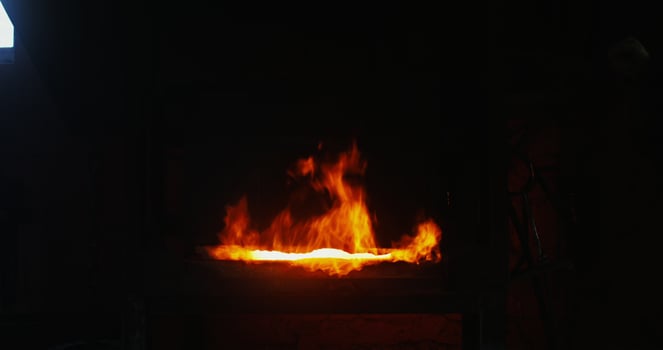 Kindled fire in the blacksmith's furnace, close-up. A strong flame breaks out of the furnace and rises up. There are no people in the . 4k , red komodo photo