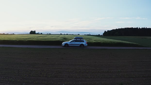 A car with a roof rack drives along the road photo