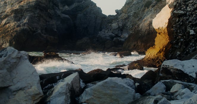 A cliff on the seashore, sea waves against a stone photo