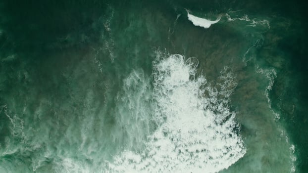 Seething seawater with foam waves, no shore, drone photo