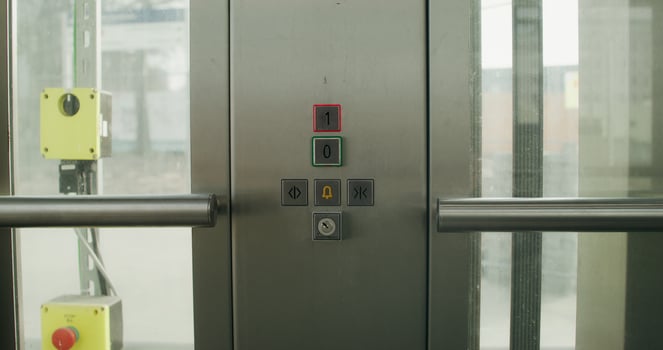 A woman presses the floor selection button in an elevator, close-up of her hand, an unrecognizable person photo