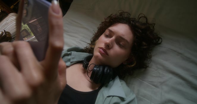 A woman laying on her back with headphones on photo