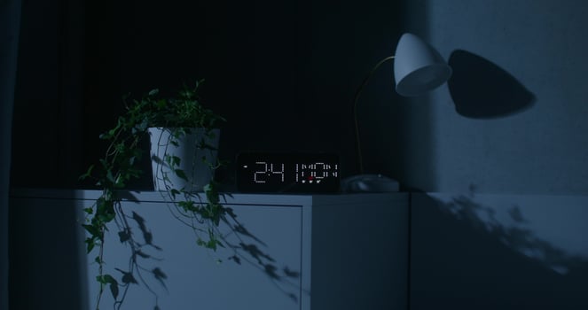 The luminous dial of the clock at home. Night time, dark room - luminous photo