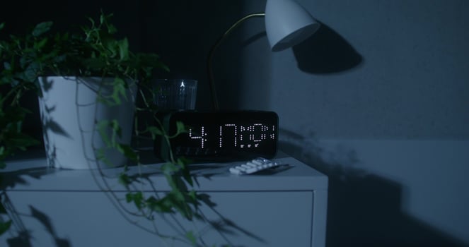 The luminous dial of the clock at home. Night time, dark room photo